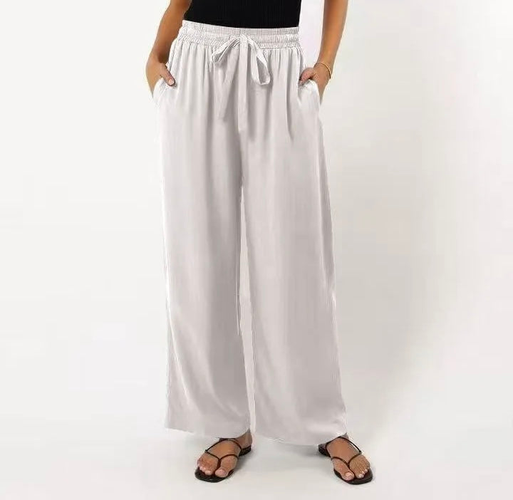 White wide-leg pants worn by a person on a white background